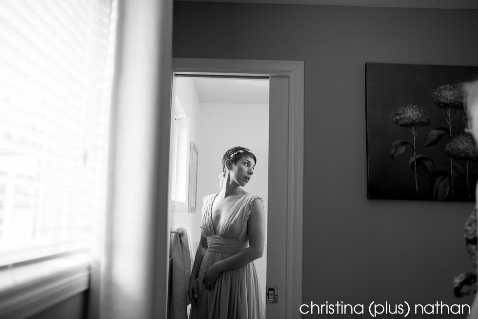 Photograph of bride looking in mirror before wedding starts