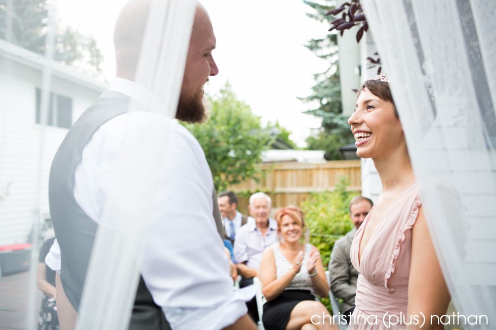 Intimate moment between bride and groom during summer wedding ceremony