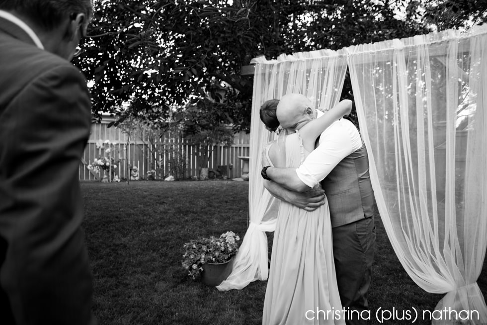 Black and White photography of sharing a hug the moment bride and groom are married