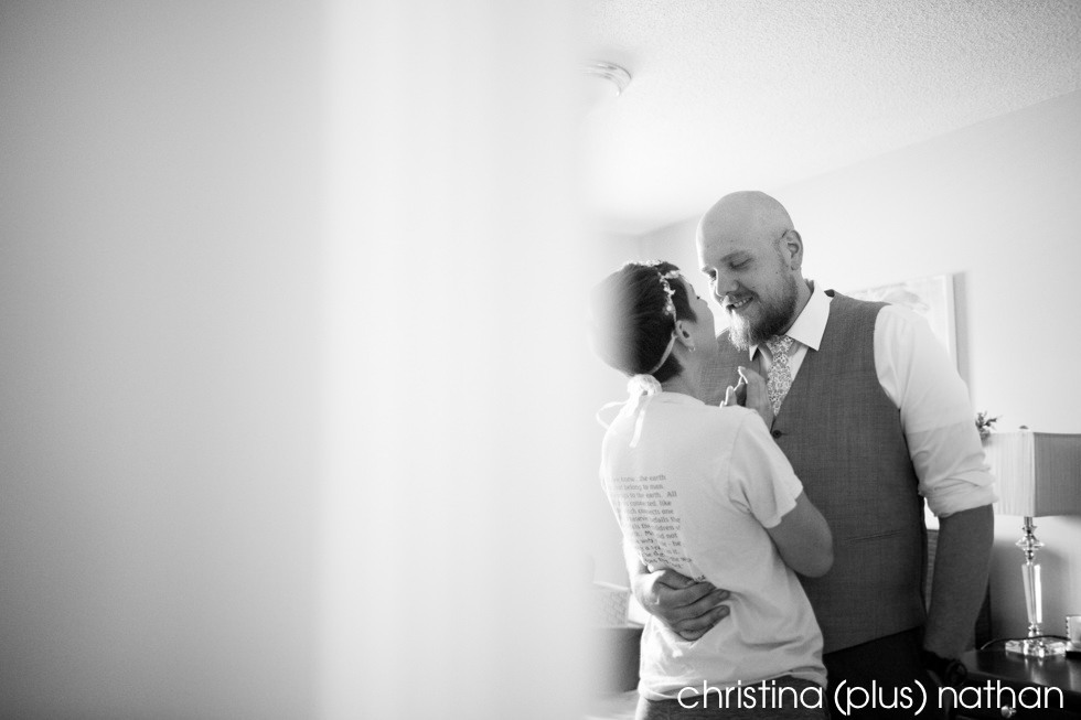 Black and White Photography of Bride and groom sneaking a kiss before wedding