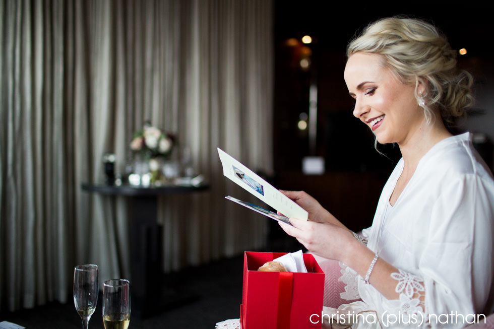 Bride opens wedding gift at Azuridge Estate Hotel