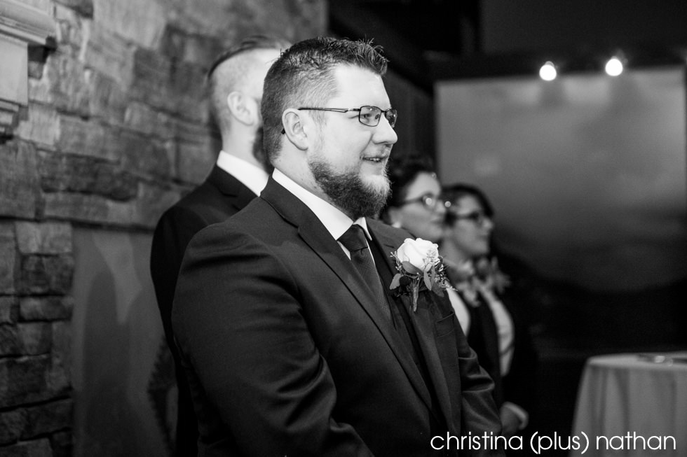 Groom watching bride come down isle