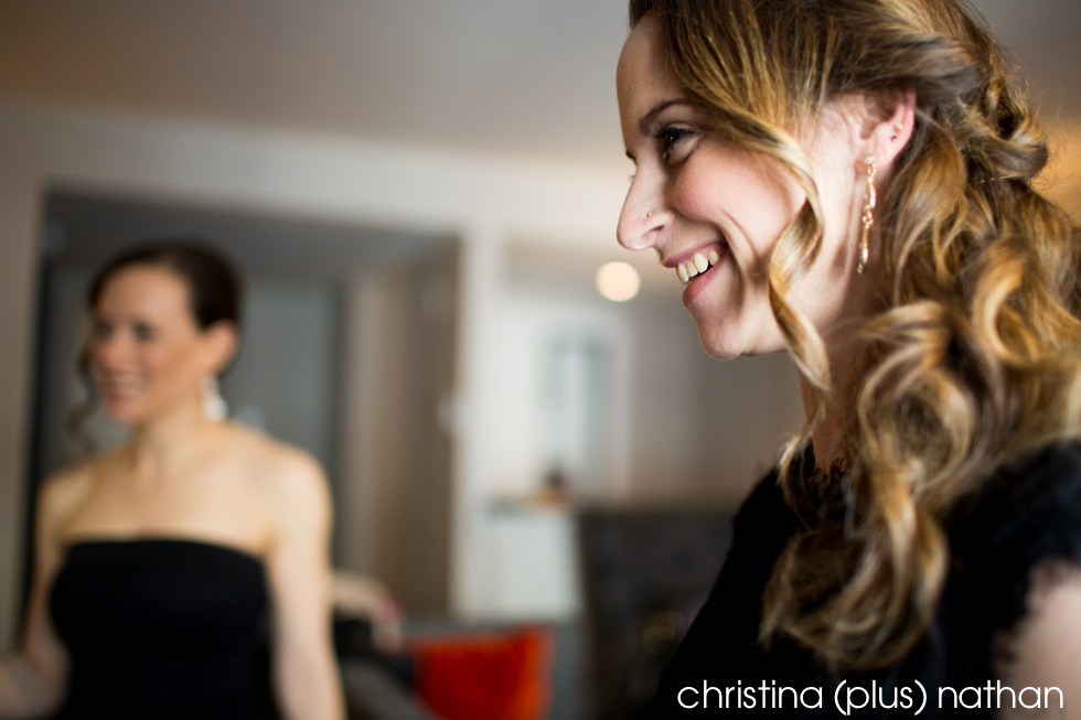 candid photography of happy bridesmaid looking at bride