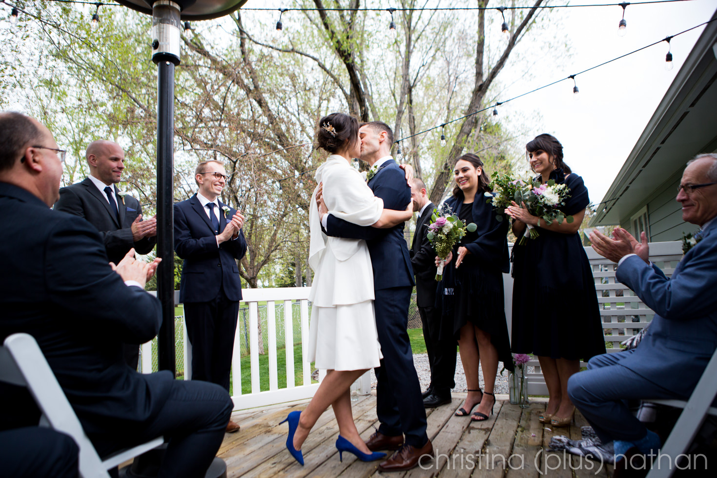 Adele and Brendan share their first kiss at their Calgary intimate backyard wedding